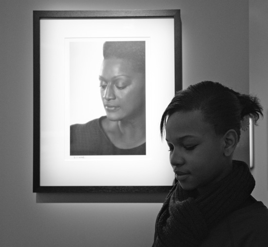 Black girl poses beside photo of Jessye Norman (Photo © Meredith Mullins)