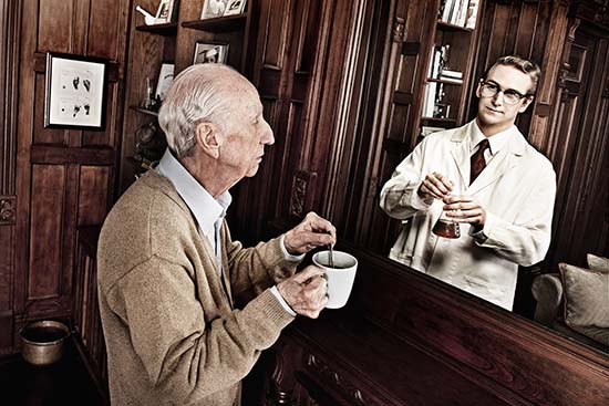 Older man with coffee sees his younger self as a scientist reflected in mirror, one of a series of creative pictures by Tom Hussey on aging. (Photo © Tom Hussey)