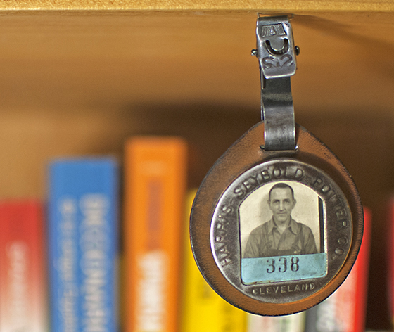 Worker's badge that includes a vintage portrait, hinting at lost life stories of the American worker. (Image © Bruce Goldstone)