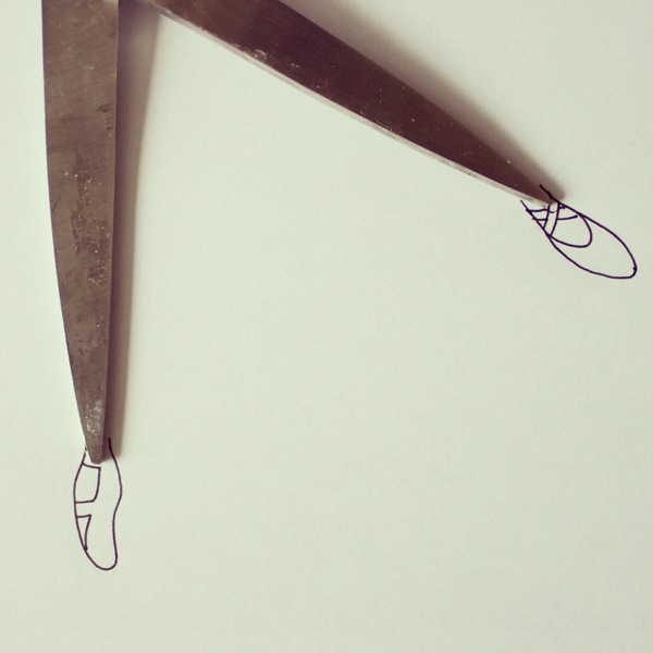 Open blades of scissors with shoes drawn at the tips to resemble human legs, all from the creative mind and imagination of Javier Pérez. (Image © Javier Pérez)