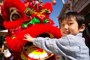 Boy hugging Chinese dragon, reflecting an animal symbol that varies in different cultures and languages. (© Digital Vision / Photodisc) 