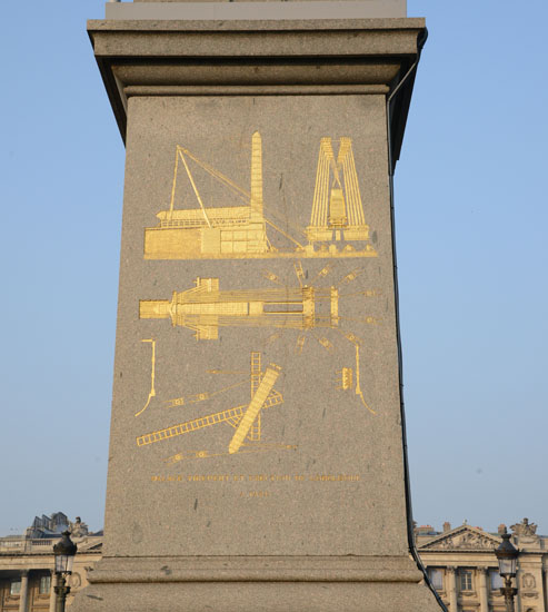 Gold images at the base of the Luxor obelisk at Place de la Concorde in Paris, part of the story to see things differently about the obelisk journey. (Photo © Meredith Mullins)