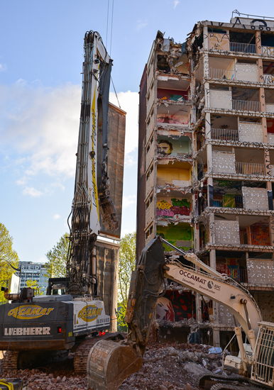A crane destroys the Tour 13 in Paris, revealing 8 stories of street art. (Photo © Pamela Fickes-Miller)
