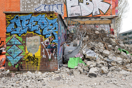 An exterior wall of the Tour 13 in Paris with a pile of rubble, proving that artistic expression is fleeting in the world of street art. (Photo © Meredith Mullins)
