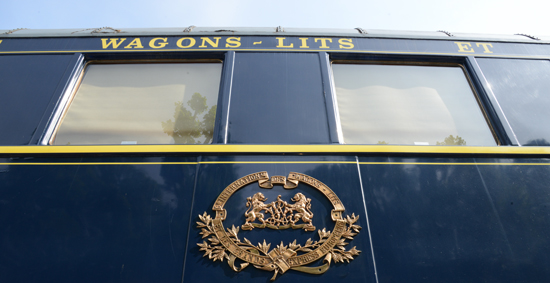 Royal crest on the side of a car of The Orient Express, a train that offered life-changing experiences as it linked two worlds. (Photo © Meredith Mullins)