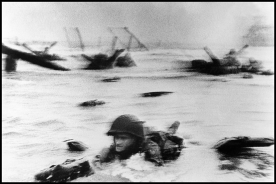 Robert Capa's photograph of a single soldier coming ashore during the Omaha Beach D-Day invasion on the longest day where life's choices made a difference. (Photo © Robert Capa/International Center of Photography/Magnum Photos)