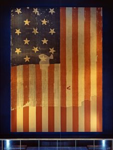 The Star Spangled Banner flag that inspired the lyrics to the US national anthem in 1814 and whose music and lyrics have been impacted by the creative thinking of subsequent generations. (Image from the Smithsonian Institution Archives)