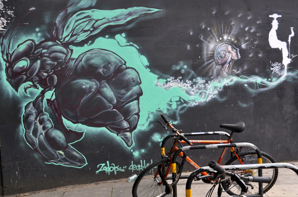 Creative street art showing a large, green wasp on a wall in Shoreditch. (Photo © Sheron Long)