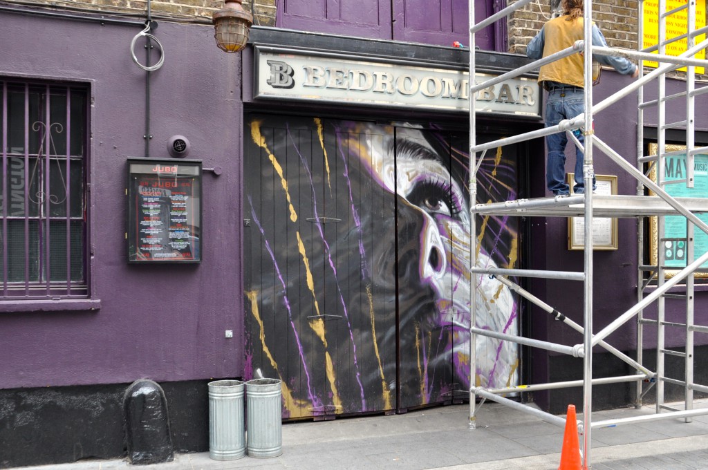 Woman's portrait painted for free on the doors of a bar by a creative street artist. (Photo © Sheron Long)