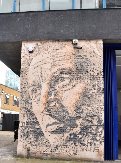 Relief portrait of a man by creative street artist VHILS (Alexandre Farto) chiseled into a Shoreditch wall. (Photo © Sheron Long)