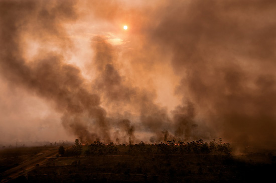 Farmers burning rainforest in the Amazon to make way for crops, life lessons on issues of the planet via photojournalism (Photo © John Stanmeyer)