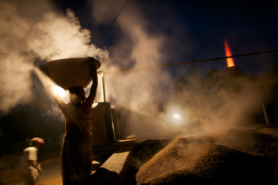 A rice-processing factory at night in Bangladesh, life lessons in survival via photojournalism (Photo © John Stanmeyer)