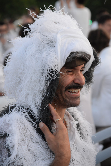 Man in feathers at the site of the Dîner en Blanc (Photo © Meredith Mullins)
