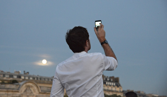 Man making photo at the site of the 2014 Dîner en Blanc (Photo © Meredith Mullins)