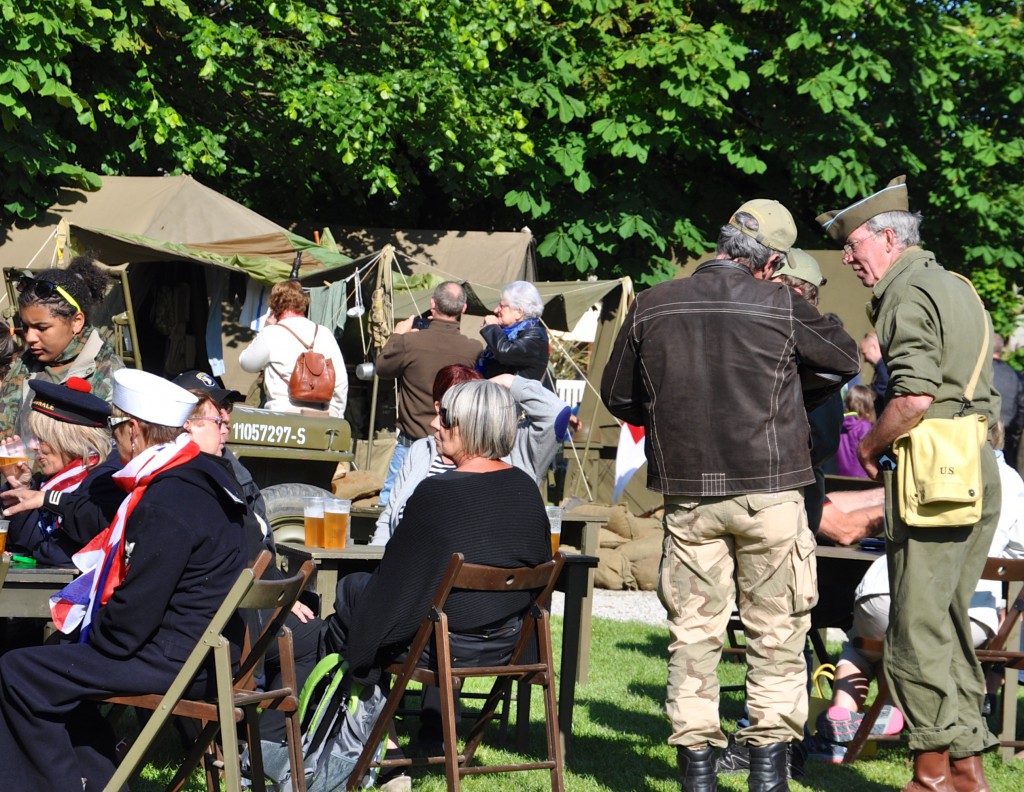 Reconstructed American Military Camp at Sainte-Marie-du-Mont during the D-Day 70th anniversary commemoration, giving militaria collectors a chance to share their gear and providing cultural encounters for visitors. (Image © Sheron Long)