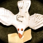 Miniature plaster dove with a letter in its mouth, illustrating one type of folk art in Mexican culture. (Image © Sheron Long)