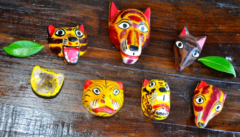 Tiny wooden masks of a cat, dog, fox, wolf, and other animals, made by a miniaturist whose work reflects Mexican culture. (Image © Sheron Long)