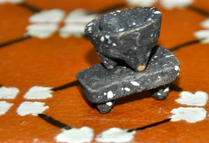 A metate, or flat grinding stone in miniature, illustrating the work of Mexican artisans preserving Mexican culture. (Image © Sheron Long)