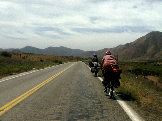 Cyclists on the highway, waiting for the dogs of Mexico and the life lessons that come with adventure cycling (Photo © Eva Boynton)