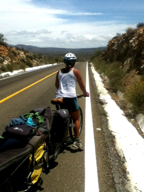 Cyclist with trailer on side of road, life lessons offered through adventure cycling and the dogs of Mexico (Photo © Eva Boynton)