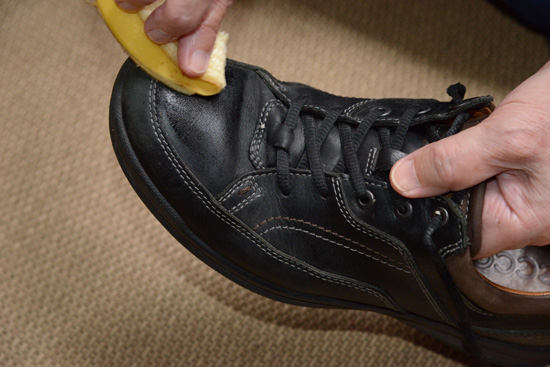 Polishing a shoe with a banana peel, representing cultural encounters and uses of bananas around the world (Photo © Meredith Mullins)