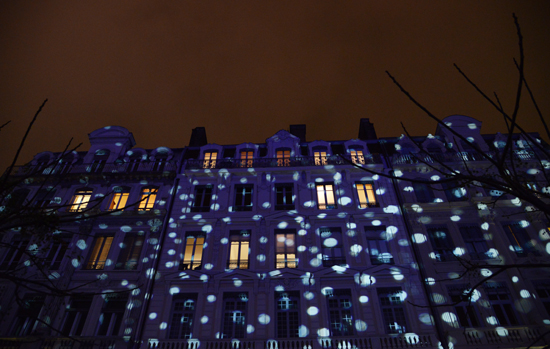 Building splattered with light, a light installation for Fête des Lumières in Lyon, showing the art of light (Photo © Meredith Mullins)