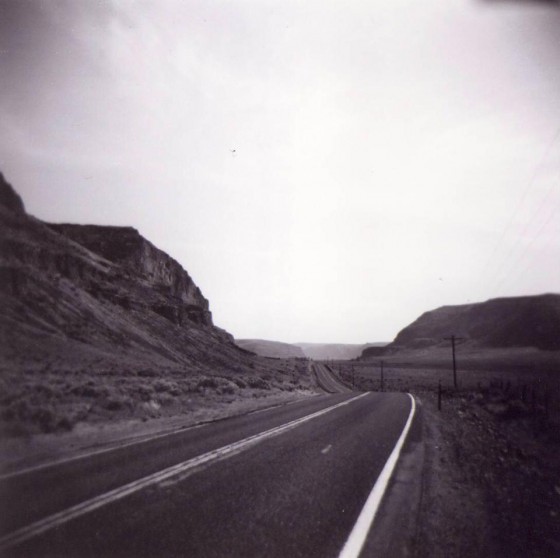 Highway stretching through mountains and valleys, illustrating the view of an on-foot traveler in a walk across America. (Image © Cirrus Wood)