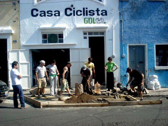 Cyclists from a bike co-op in Guadalajara turning a car parking space into bike parking. (Image © Casa Ciclista)
