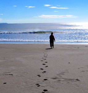 Footprints on a pristine Costa Rica beach, illustrating a powerful New Year's resolution to make your mark on the world. (Image © Robert Long)