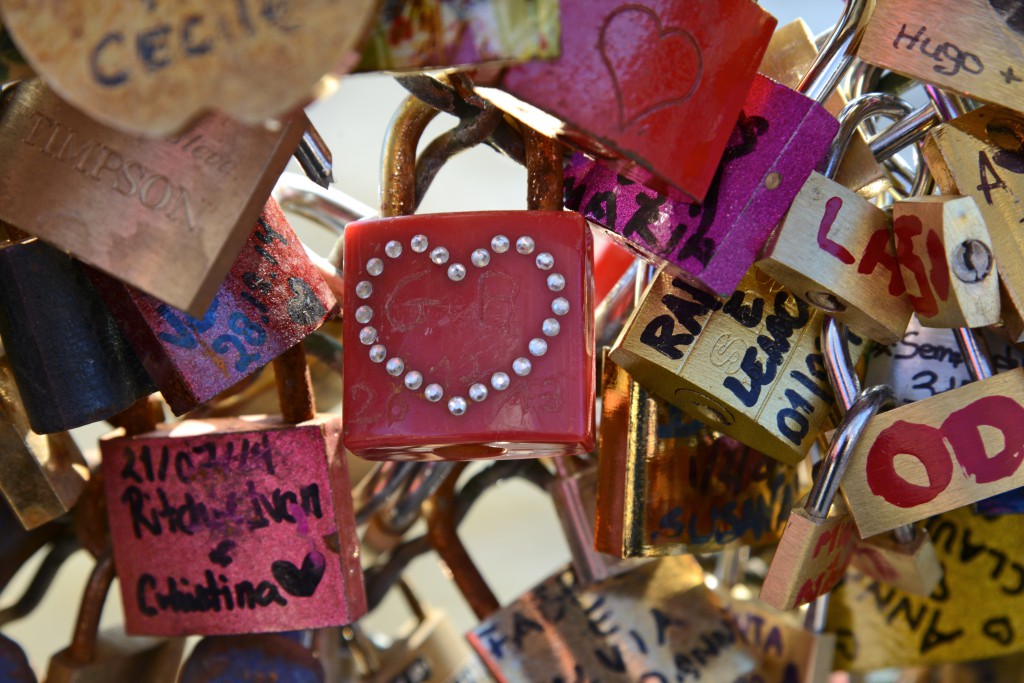 Red heart in maze of Paris love locks showing romance in Paris and answering the question Can Love Conquer All (Photo © Meredith Mullins)