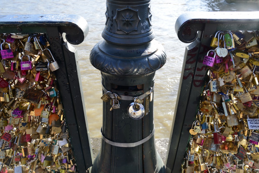 Bridge and lamppost with love locks, a tribute to romance in Paris and the idea of "Can Love Conquer All?" (Photo © Meredith Mullins)