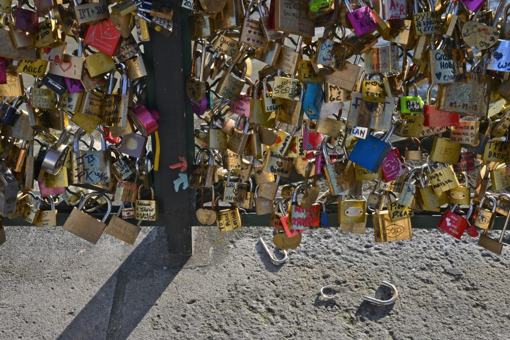 Love locks on the Pont des Arts, with broken lock parts, a tribute to romance in Paris and the idea of "Can Love Conquer All? (Photo © Meredith Mullins)