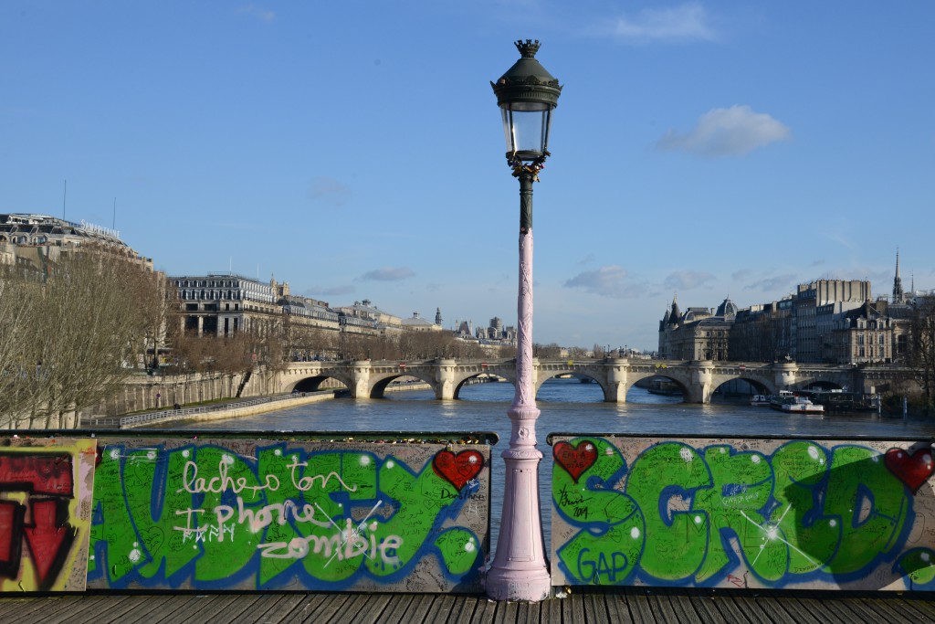 Plywood on the Pont des Arts, covering the love locks and bringing back romance in Paris and the idea of "Can Love Conquer All?" (Photo © Meredith Mullins)