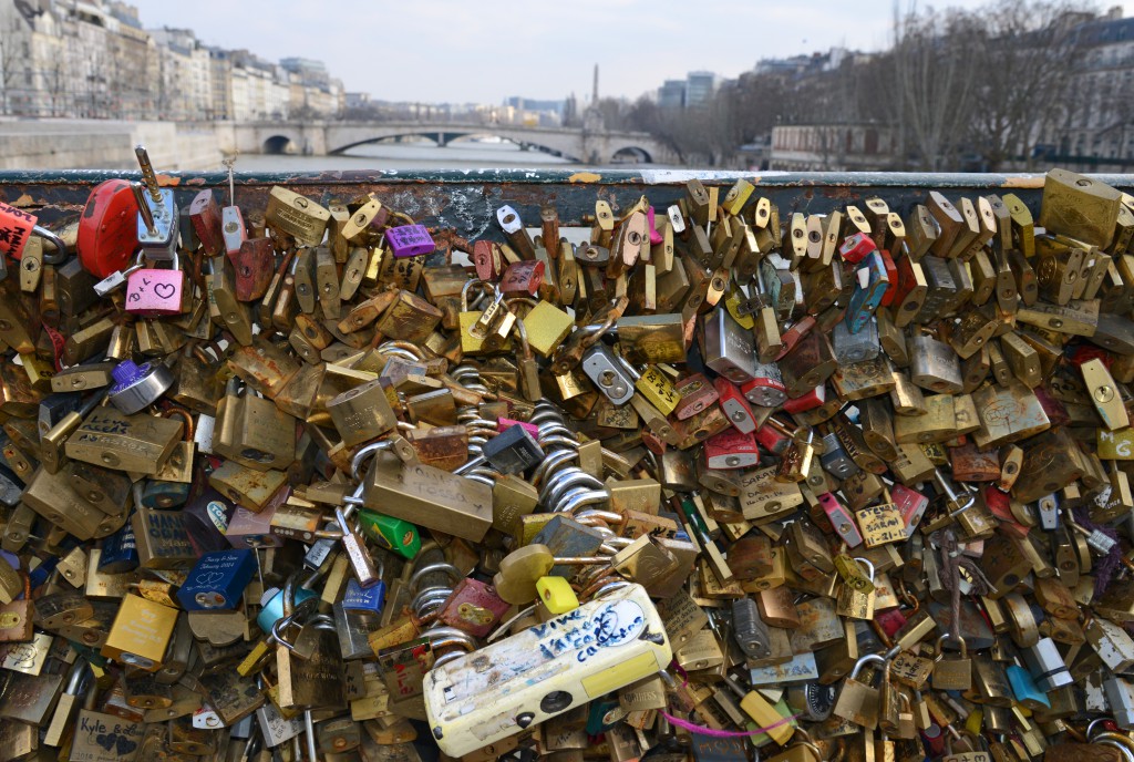 Paris bridge with many love locks, a tribute to romance in Paris and the idea of "Can Love Conquer All?" (Photo © Meredith Mullins)