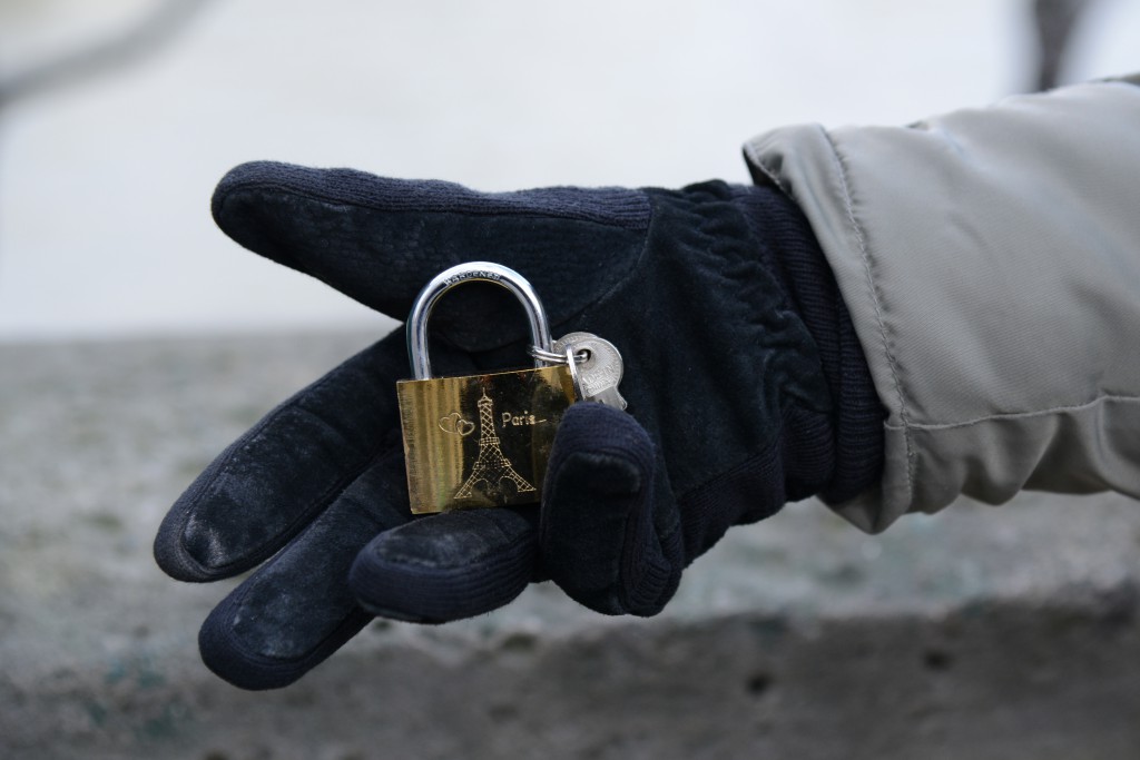 Love lock close up in black glove, a tribute to the love locks of Paris, romance in Paris, and the idea of "Can Love Conquer All?" (Photo © Meredith Mullins)