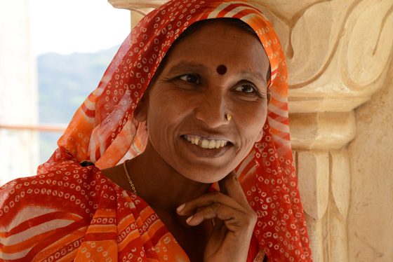 Woman in orange, cultural encounters in Northern  India that provide travel inspiration. (Image © Meredith Mullins)