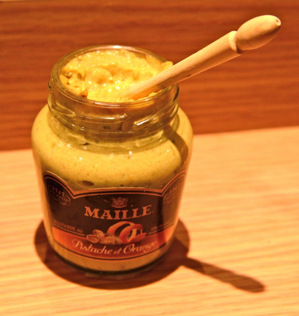 Jar of Maille mustard with spoon, showing the focus of food in French sayings. (Image © Meredith Mullins)