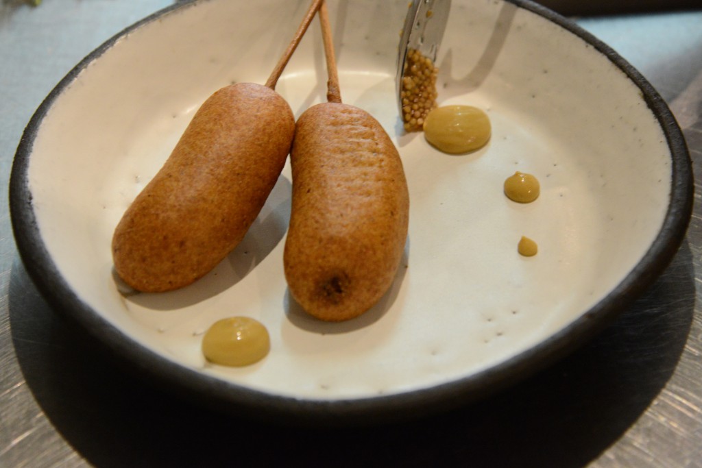 Close up of Ellsworth corn dogs with mustard, showing the focus on food in French sayings. (Image © Meredith Mullins)