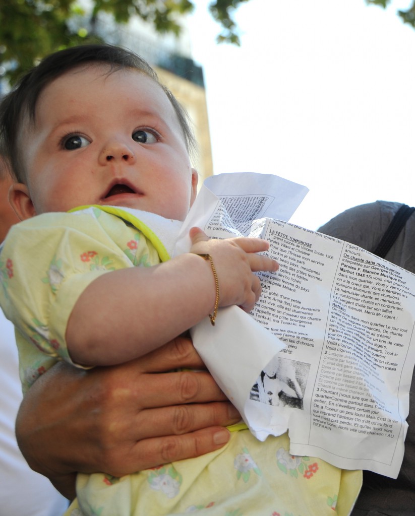 Baby with song lyrics at le petit bal on the rue Mouffetard, showing the universal language of music. (Image © Meredith Mullins)