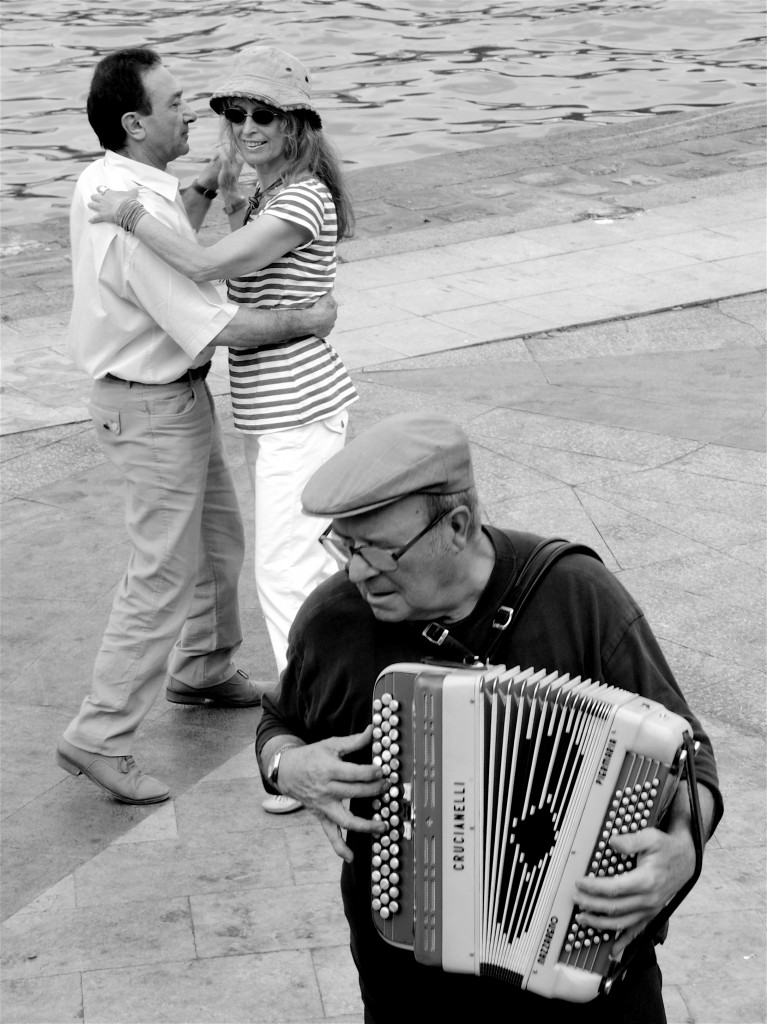 B&W photo of dancers by the Seine, part of the rue Mouffetard group, showing the universal language of music. (Image© Meredith Mullins)
