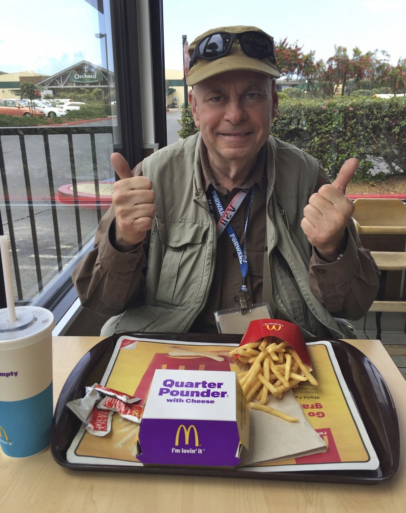 Man with McDonald's quarter pounder, showing cultural differences in fast food. (Image © David Taggart)