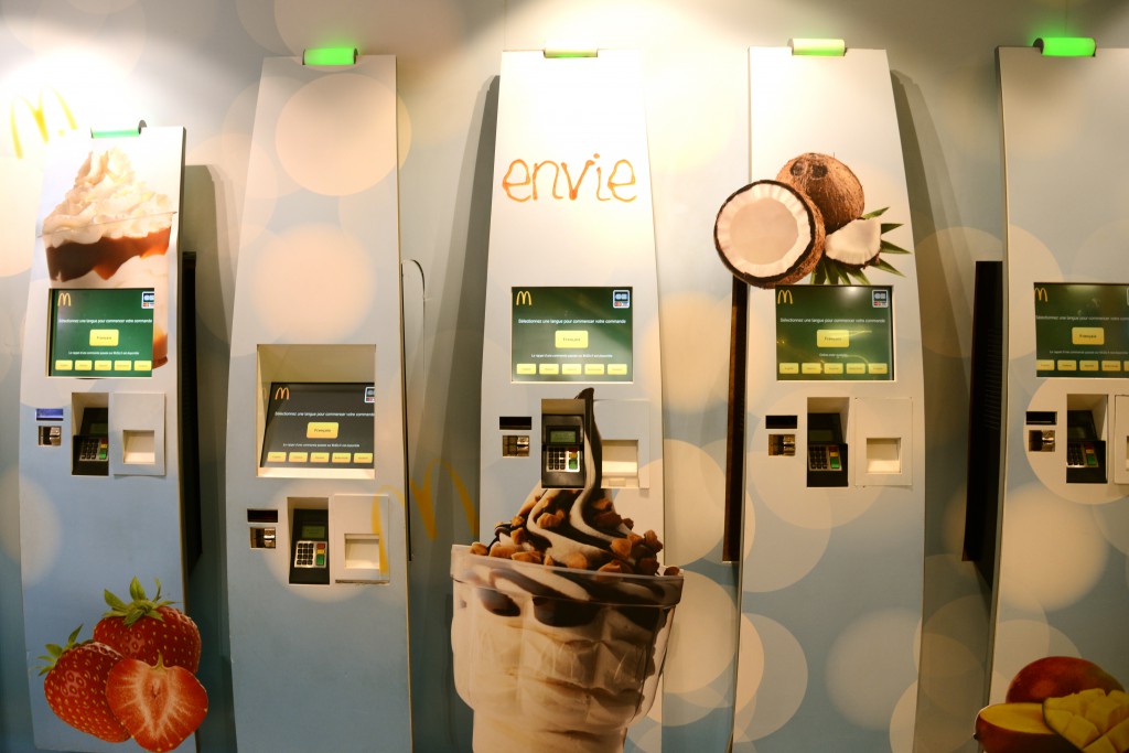 Touch screens at McDonald's for ordering, showing cultural differences in fast food. (Image © Meredith Mullins)
