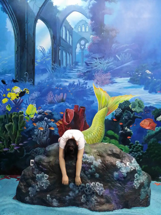 Person pretending to be a mermaid in the interactive 3D art painting, which provides rich opportunities for selfies in the interactive 3D Art in Island Museum in the Philippines. (Photo courtesy of Art in Island Museum.)
