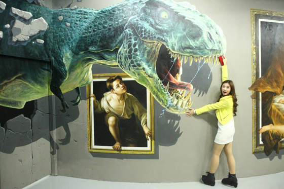 Young woman pretending to hold mouth of sea monster open in the interactive 3D art painting, which provides rich opportunities for selfies in the interactive Art in Island Museum in the Philippines. (Photo courtesy of Art in Island Museum.)