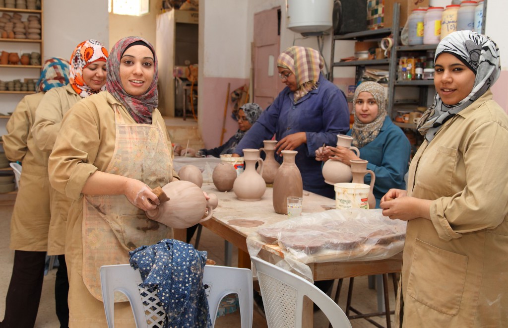 Women making and selling pottery at a co-op near Wadi Rum, Jordan in hopes of bridging cultural barriers. (Image © USAID)