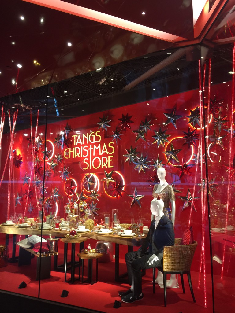 A dinner table in the window of Tang's store in Singapore, one of the holiday traditions that shows cultural differences. (Image © Catherine Lawrie.)