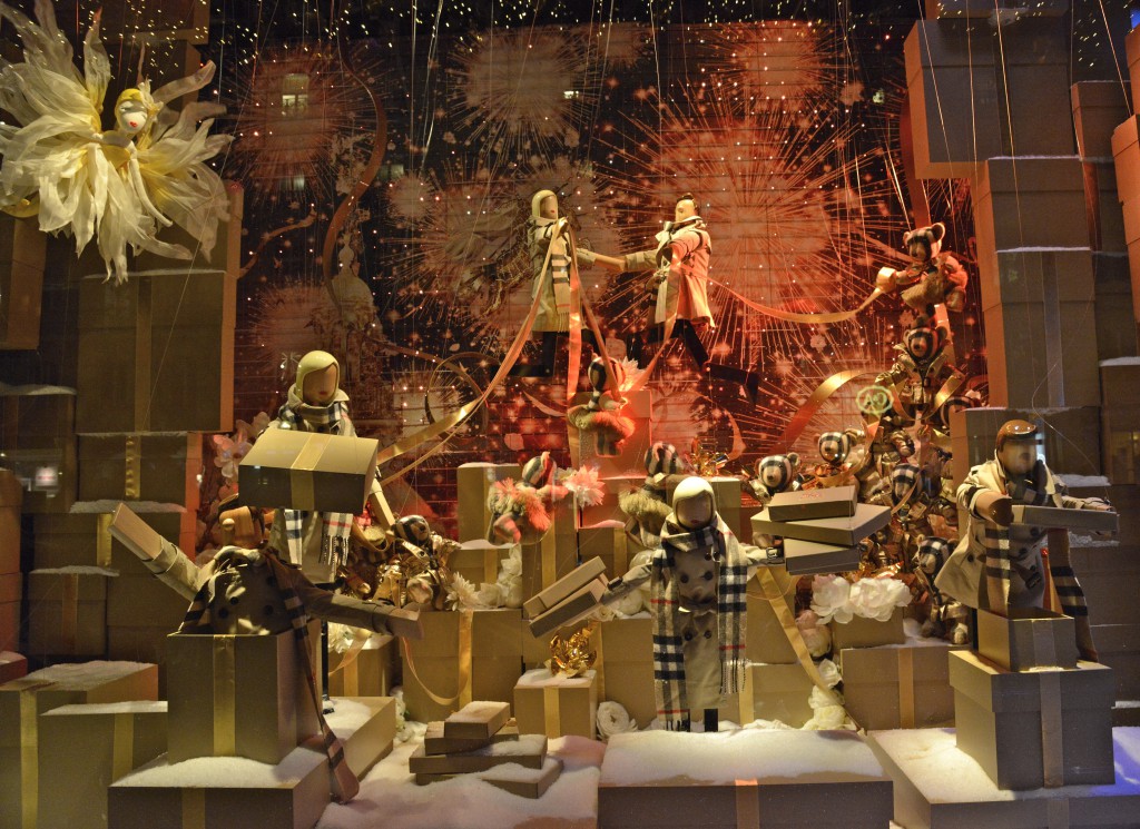 Store window with figures wearing Burberry scarves, one of the holiday traditions showing cultural differences. (Image © Meredith Mullins.)