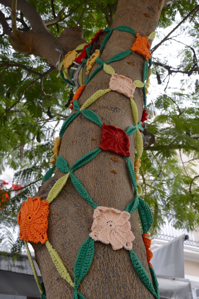 Small knit squares in tree, part of the carnival celebrations in the Canary Islands, travel adventures of the best kind. (Image © Meredith Mullins.)