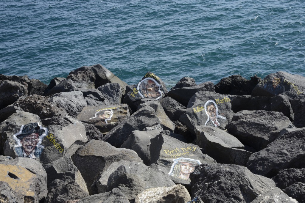 Rocks with portraits of musicians, part of the carnival celebrations in the Canary Islands, travel adventures of the best kind. (Image © Meredith Mullins.)