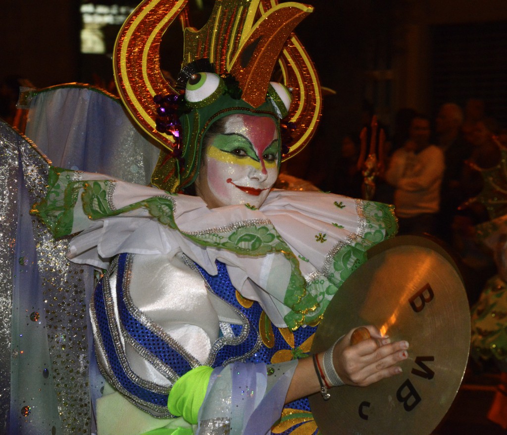 Carnival participant with cymbals as part of the carnival celebrations in the Canary Islands, travel adventures of the best kind. (Image © Meredith Mullins.)